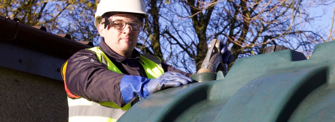 Johnston Oil man topping up oil