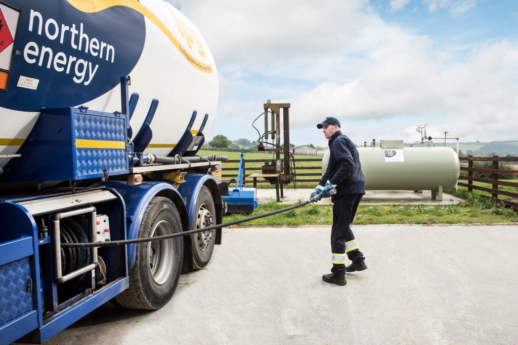 LPG Driver pulling hose to tank